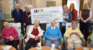 Staff and residents fromHanover Court Dunfermline Social Group with giant cheque from Lintel Trust