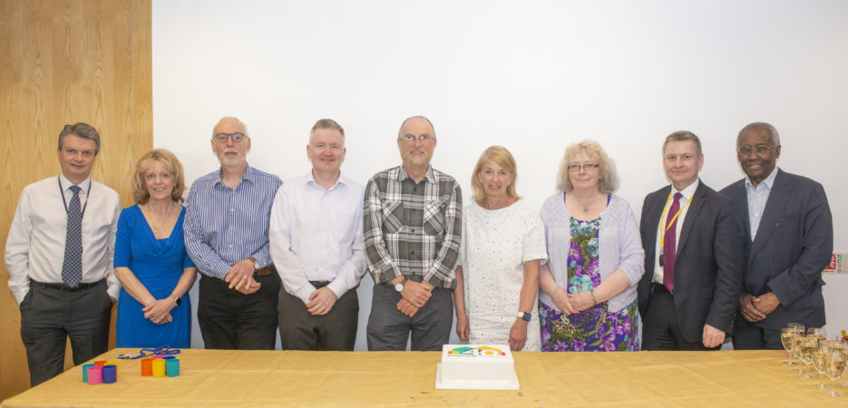 the Hanover board cutting a cake