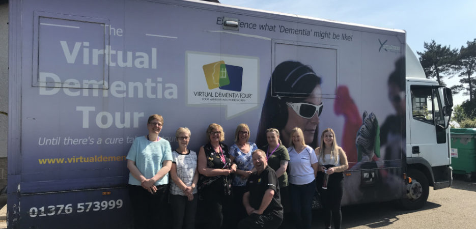 staff outside the virtual dementia tour bus